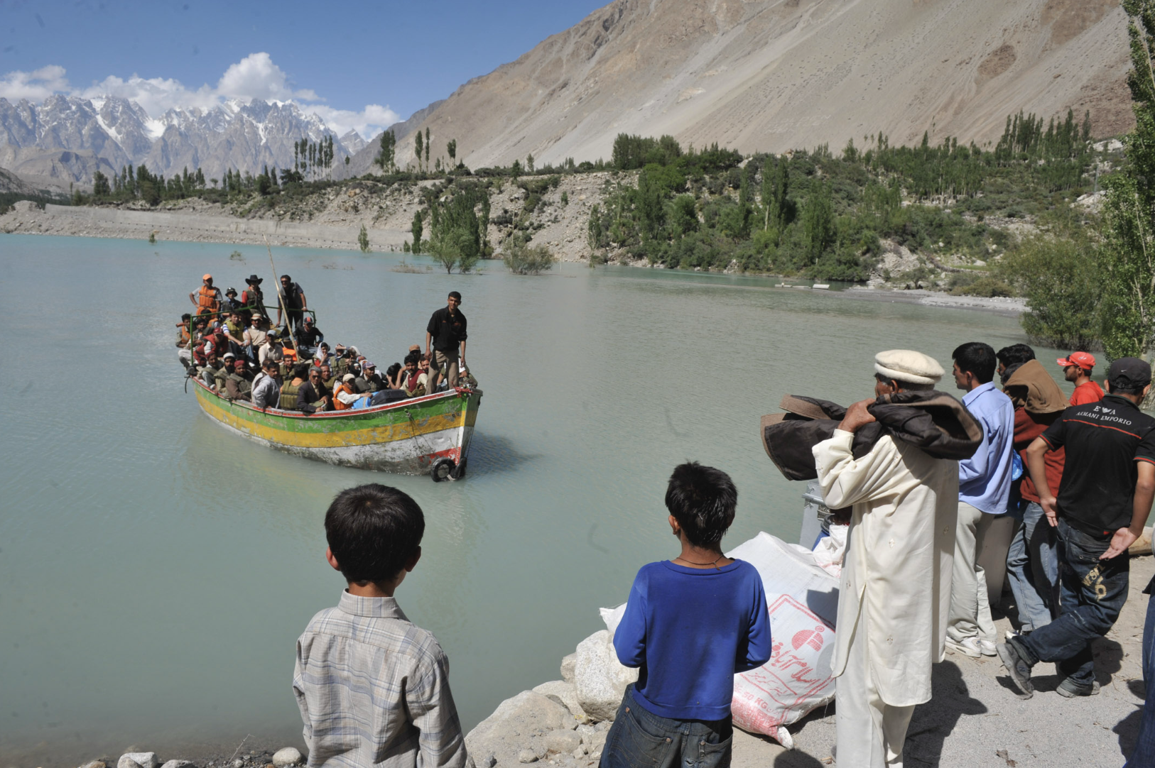   Upper Hunza, Pakistan — 2010:  A landslide dammed the Hunza River, forming Attabad Lake and cutting road access along the Karakoram Highway, forcing displaced residents to move by boat and improvised routes. (Photo/Mark Pearson) 