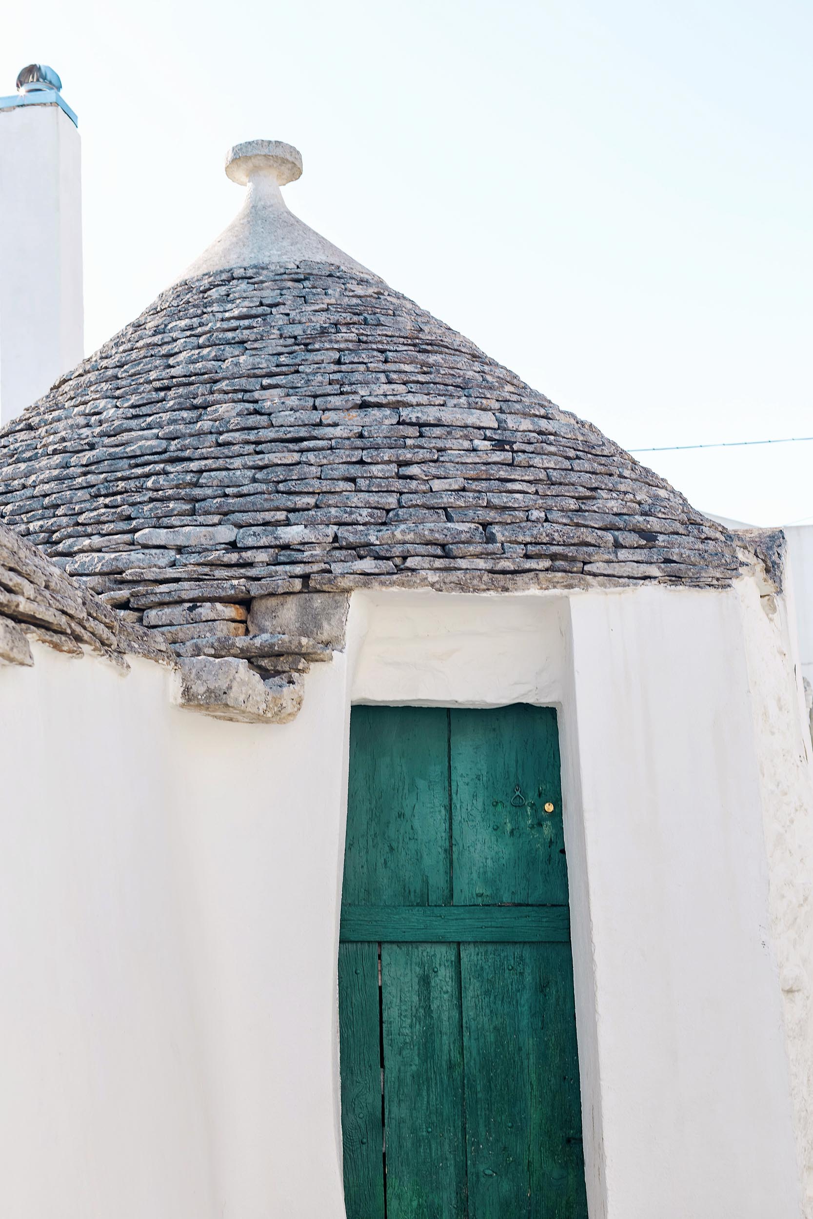 A teal door on a trullo building in Puglia