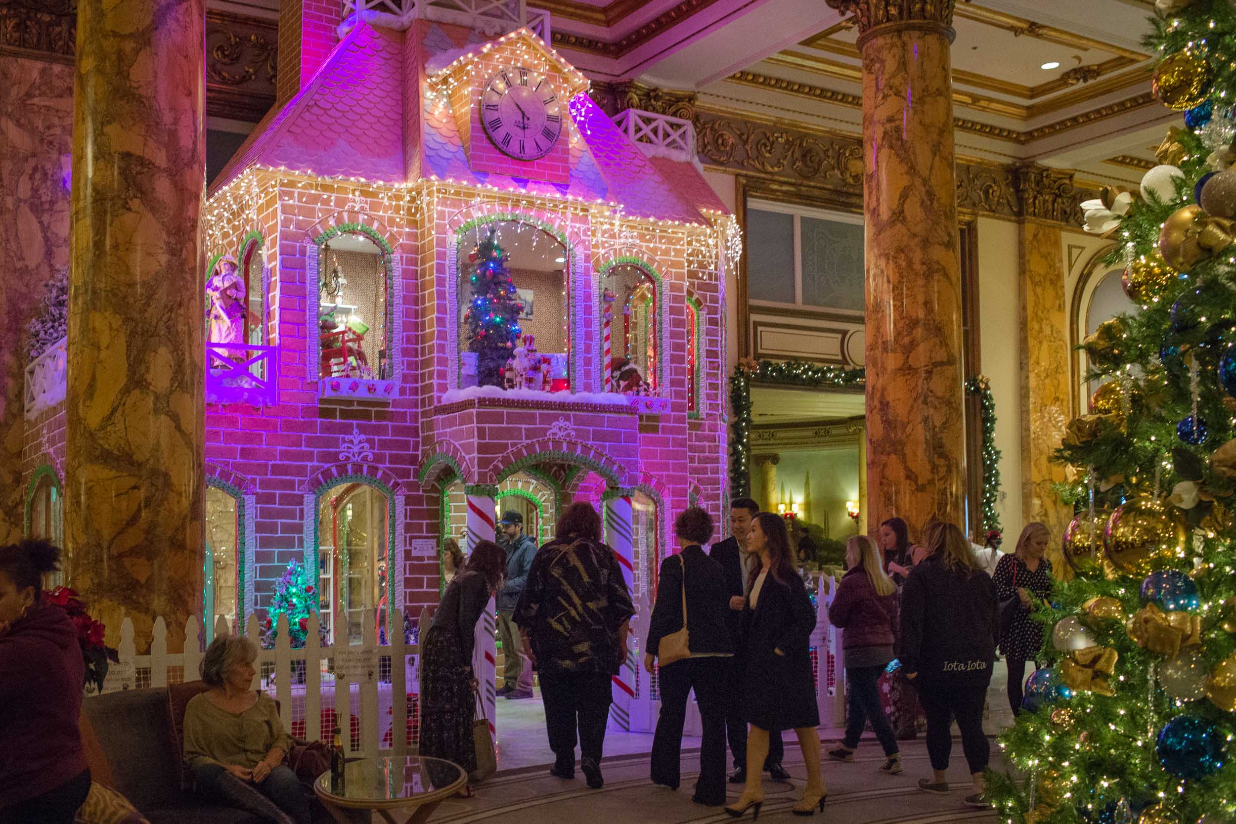 The lobby of The Fairmont San Francisco at Christmas time features a 23-foot tree and a real, two-story Gingerbread House!