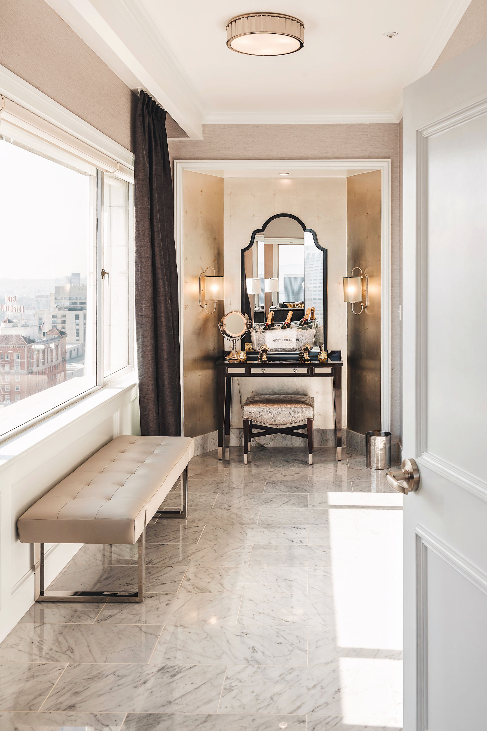 The spa bathroom in the Presidential Suite at the Fairmont San Francisco is beyond glamorous and includes a double vanity, marble shower and an infinity bathtub with city views