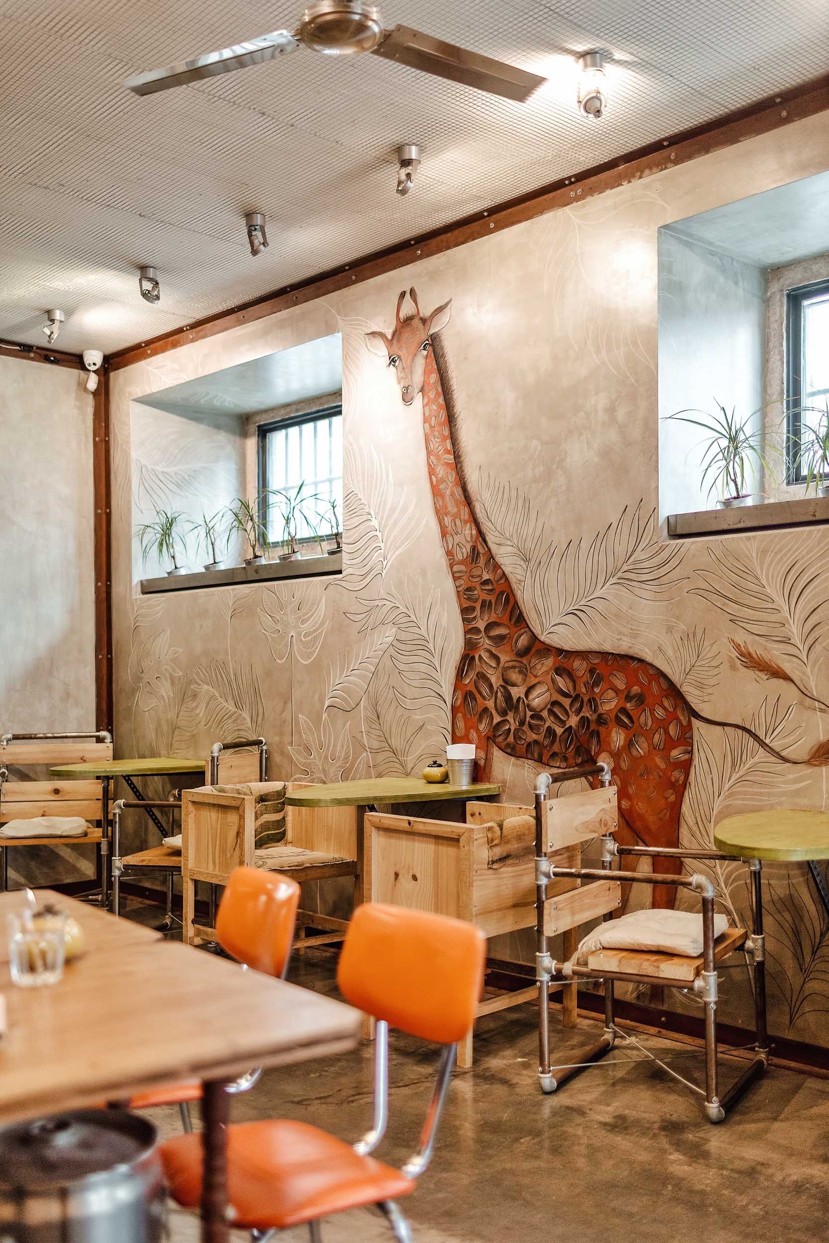 The interior of Fabrica Coffee Rosters in Lisbon.  The giraffe's spots are coffee beans!