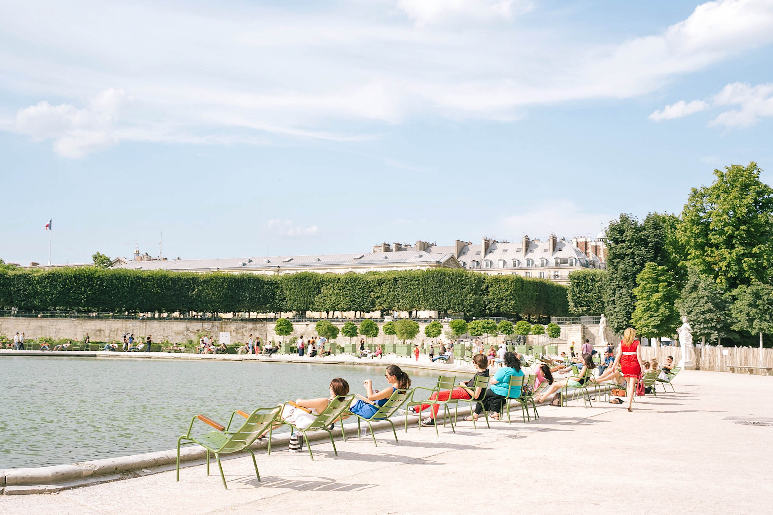 Summer in Paris - the Seine is lined with people dangling their feet over the edge, the Eiffel Tower lawn with picnic-goers, and every cafe, restaurant, and bar with outdoor diners.