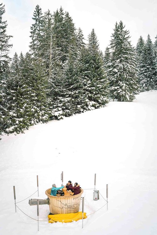Eating fondue in the Swiss Alps in a large wooden fondue pot