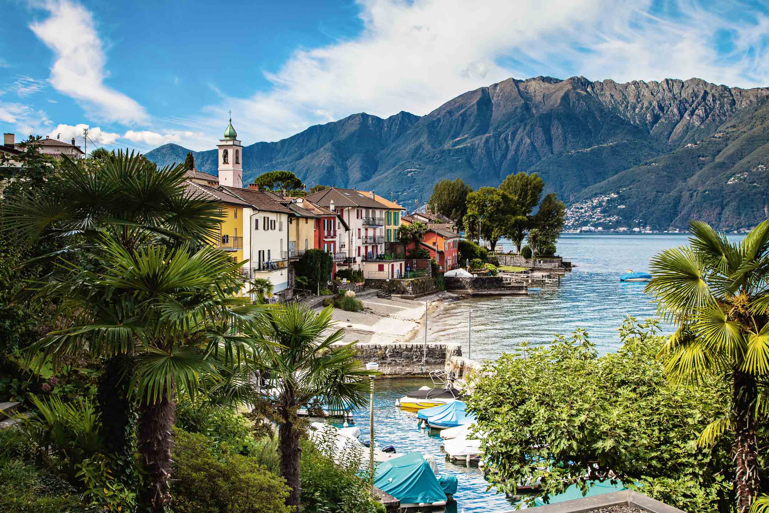 Small harbor with colorful row of houses on Lake Maggiore, Gerra (Gambarogno). Copyright by: Switzerland Tourism