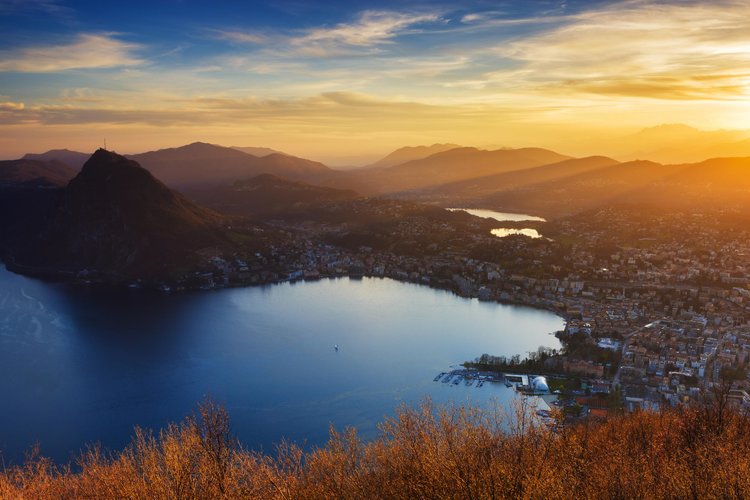 Evening view from Monte Bre (925 m) of Lugano and the San Salvatore (912 m). Copyright by: Switzerland Tourism
