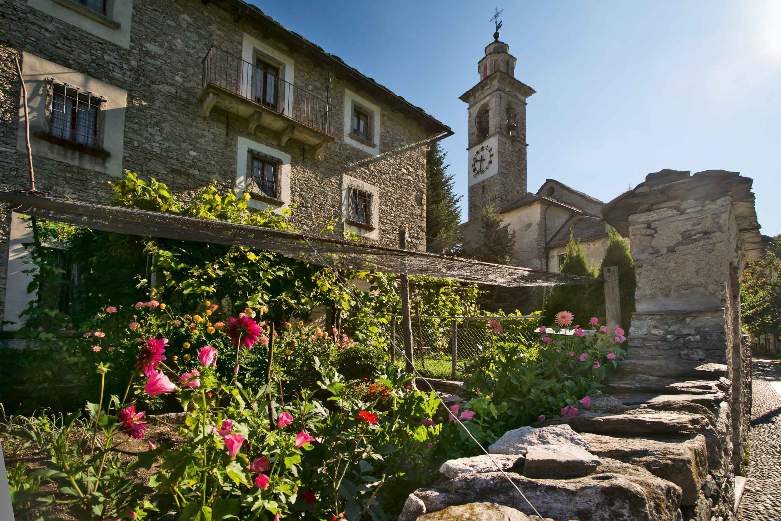 The church tower of St. Anne in Rasa in the Centovalli. Rasa is one of the smallest municipalities in Ticino. Only about 20 people live here year round. Copyright by: Switzerland Tourism