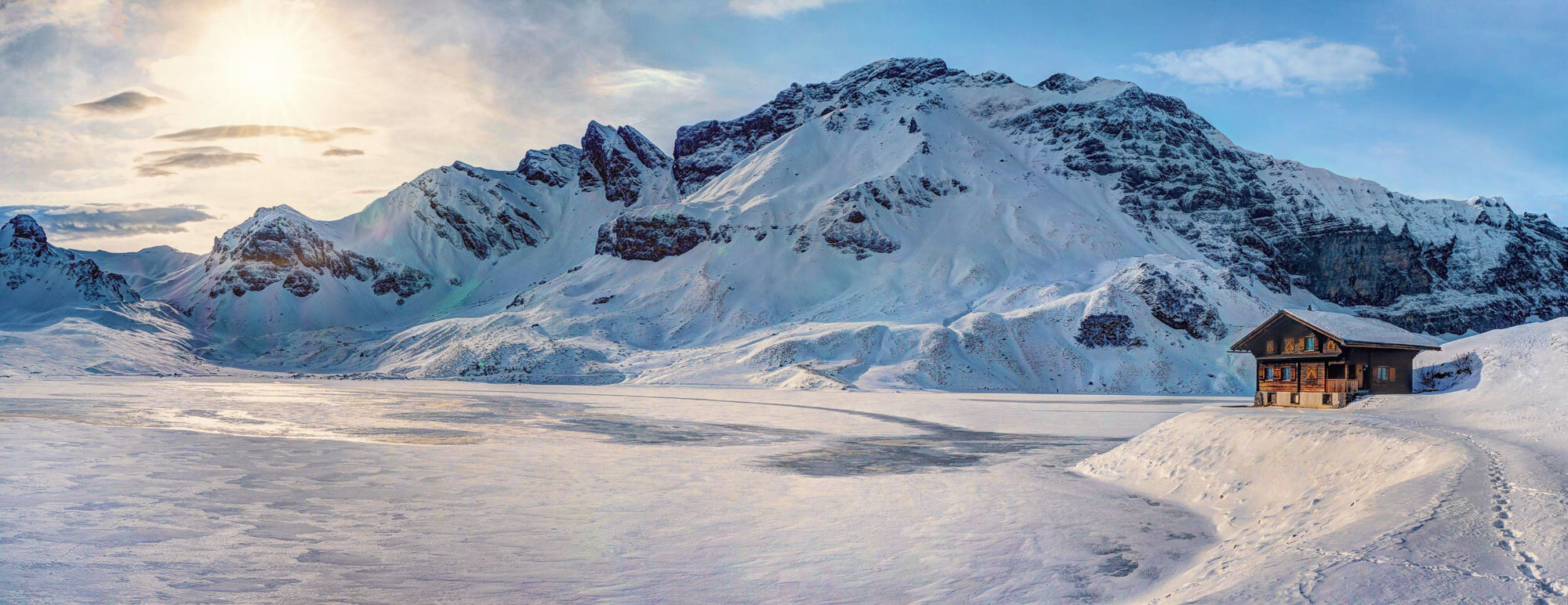 Panorama on the Melchsee-Frutt with the frozen mountain lake. Copyright by: Switzerland Tourism