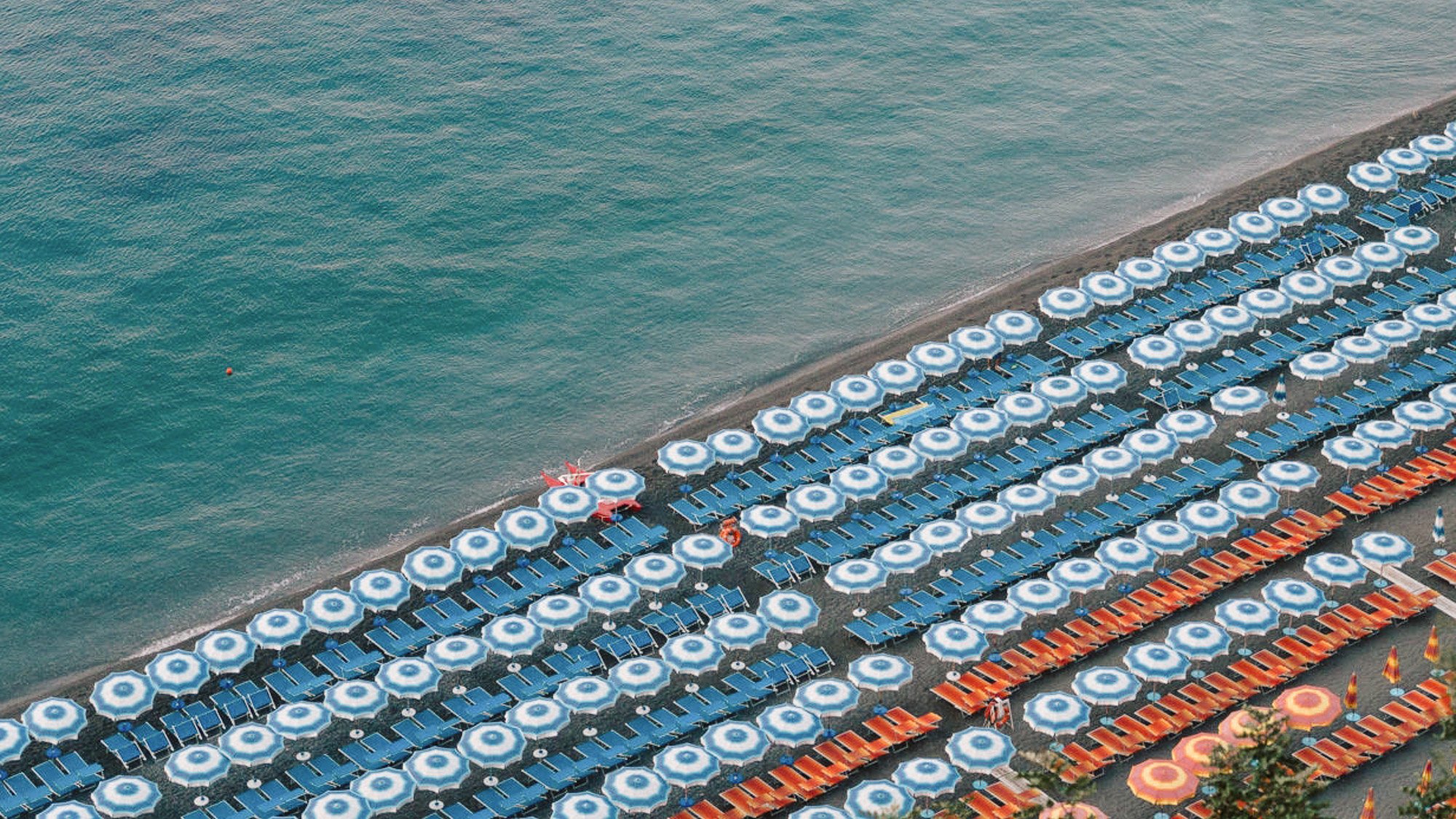 Rows of perfectly lined sun chairs at Positano beach