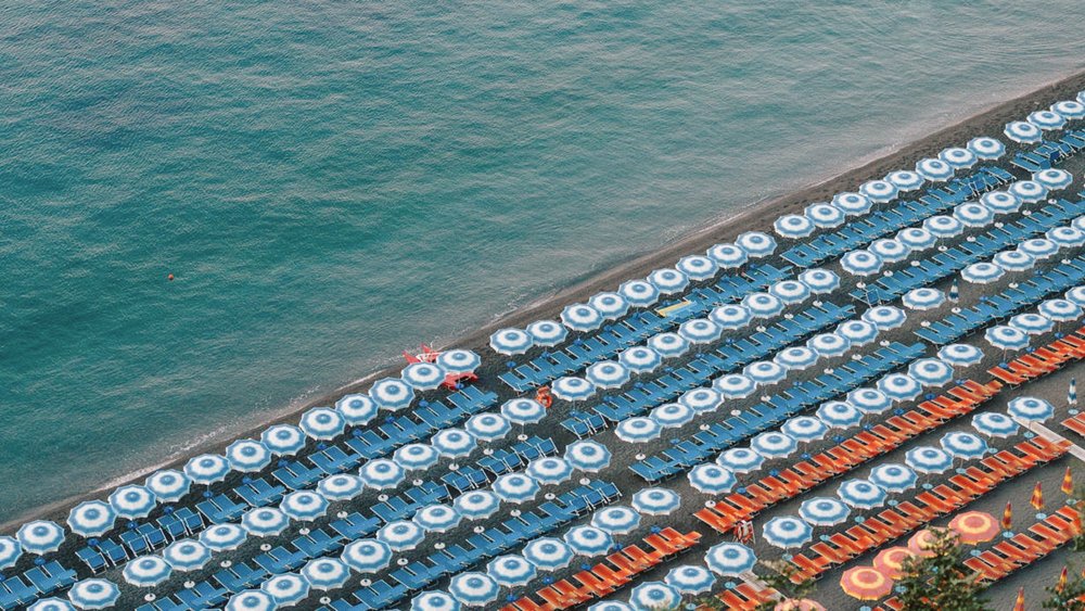 Rows of perfectly lined sun chairs at Positano beach