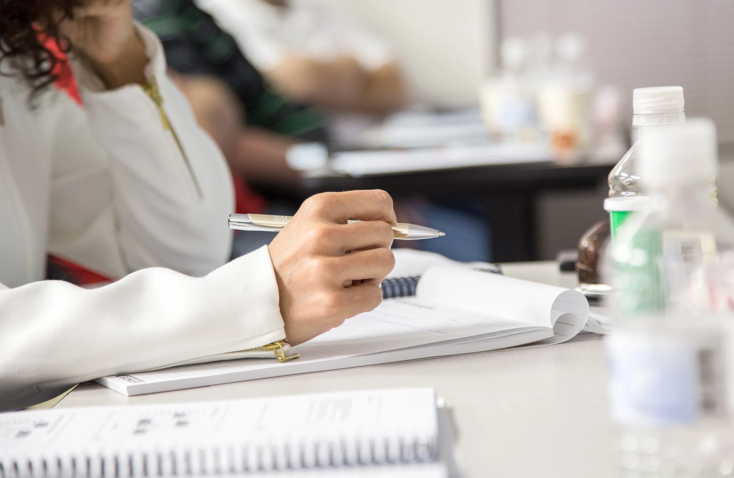 Corporate event photography by Cheryl Gottschall: A close-up of a participant taking notes during a training session at Bühler Aeroglide.