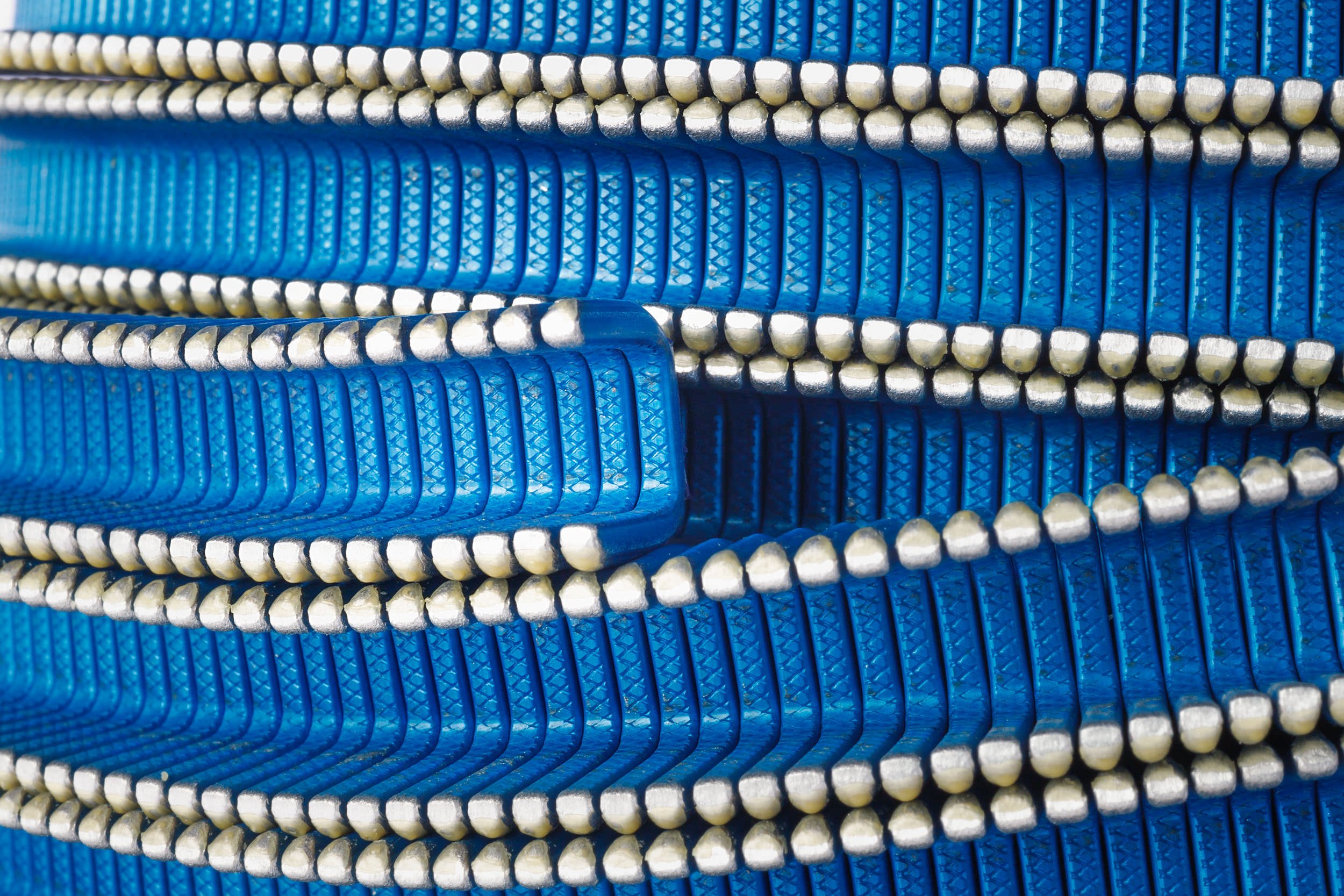 Technical and Commercial Product Photography Raleigh NC: Macro detail shot of industrial clipping components for Tipper Tie by Gottschall Photo.