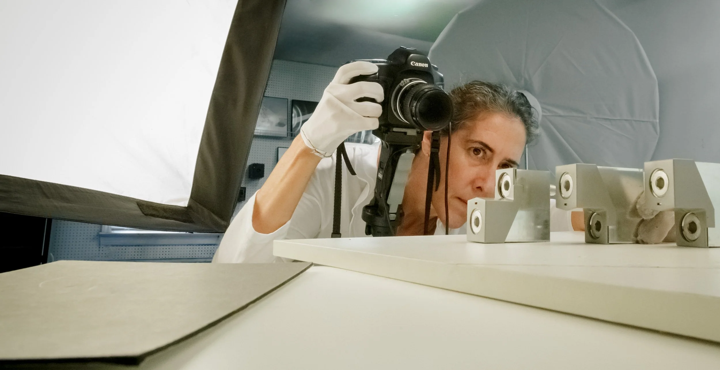 Photographer Cheryl Gottschall photographing small product in her studio at Gottschall Photography.