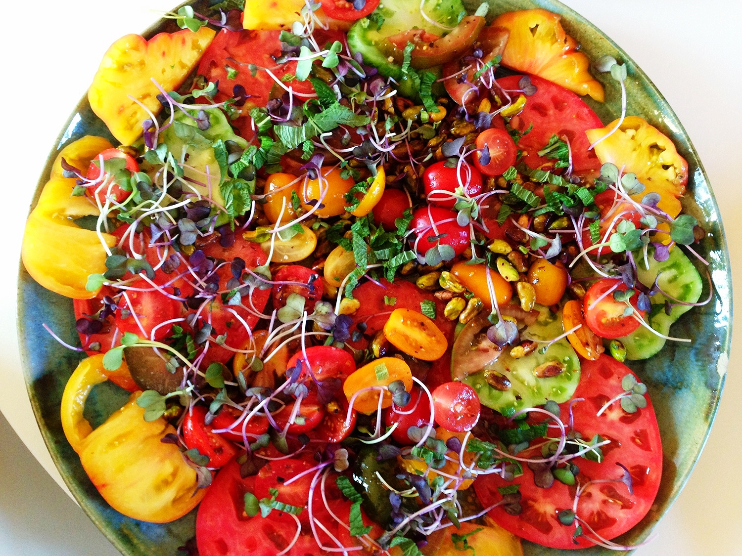 Heirloom tomato salad, broccoli sprouts, pistachios, and garden herbs