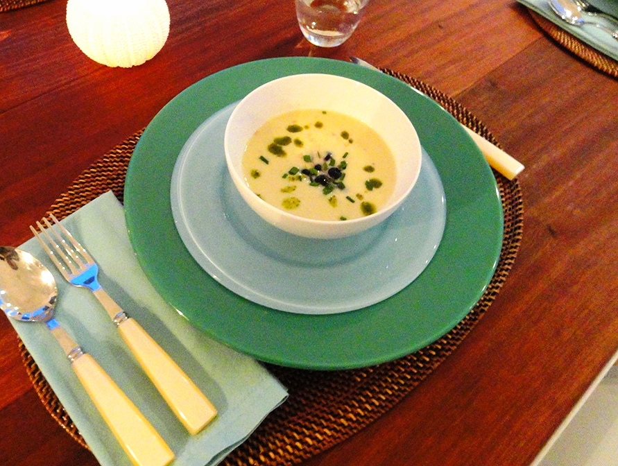 Cold corn soup with pickled blueberries and basil oil