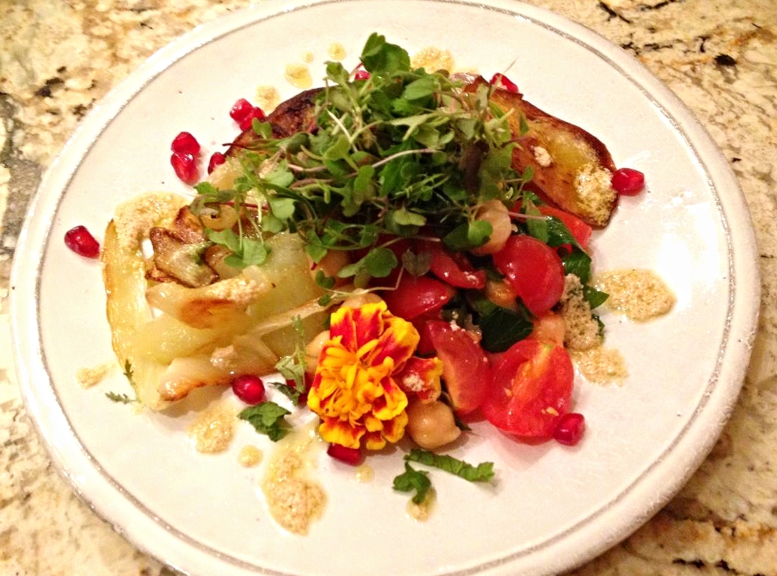 Roasted cauliflower, eggplant, tomato, and chickpea salad with pomegranate, microgreens and lemon-tahini dressing