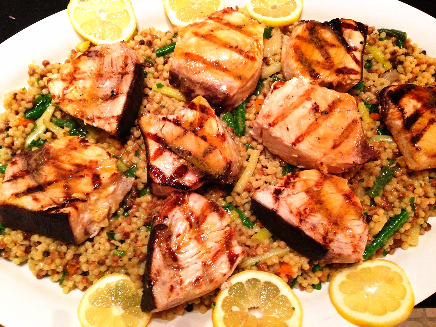 Grilled swordfish steaks on Israeli couscous with green and wax beans, herbs, and lemon citronette