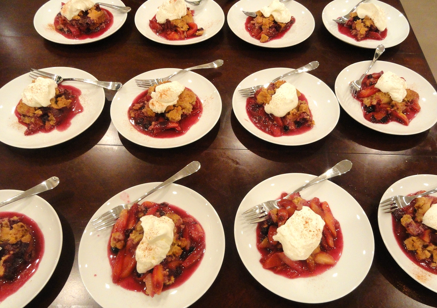 Warm summer stone fruit crisp with whipped cream