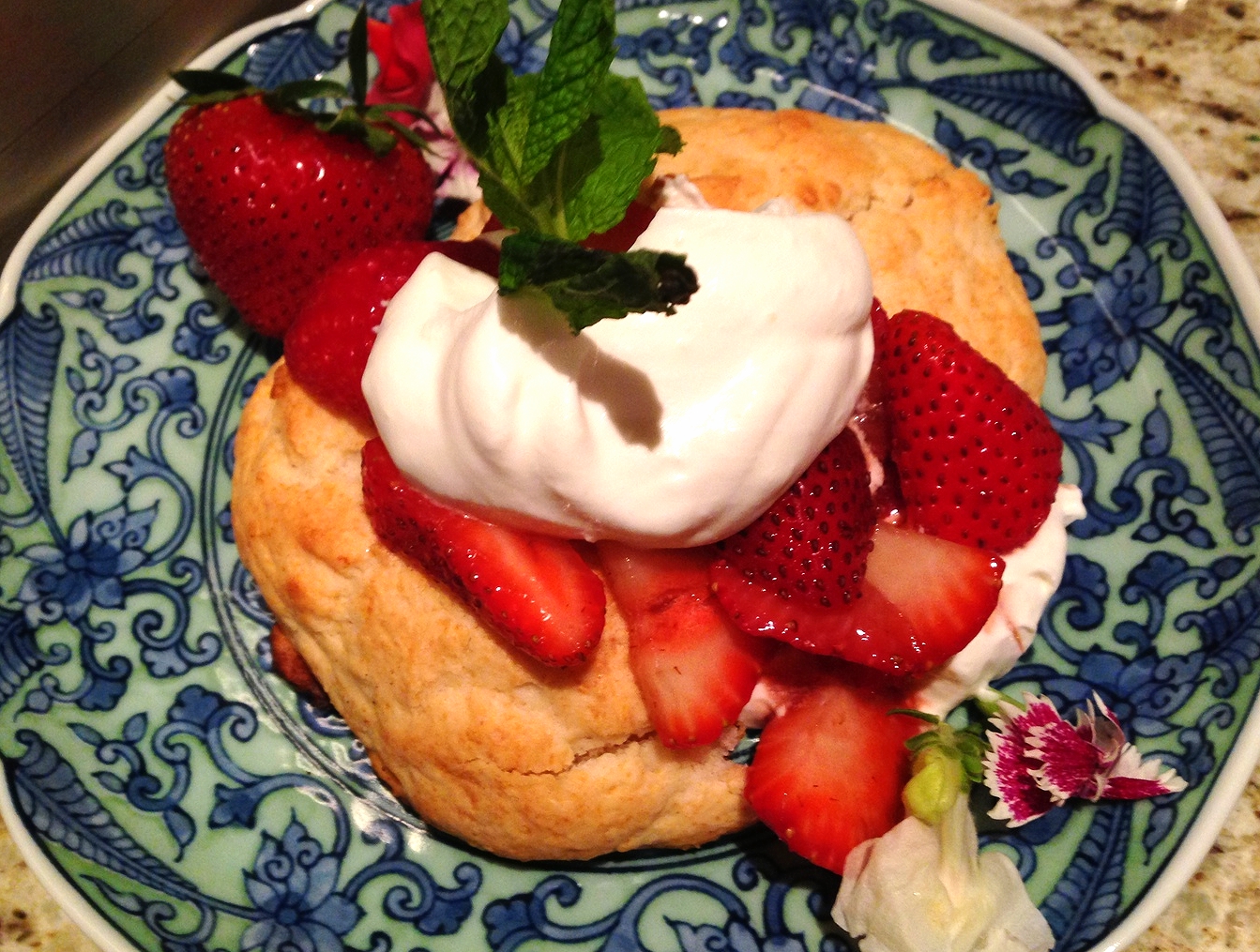 Strawberry shortcake with whipped cream and sliced strawberries
