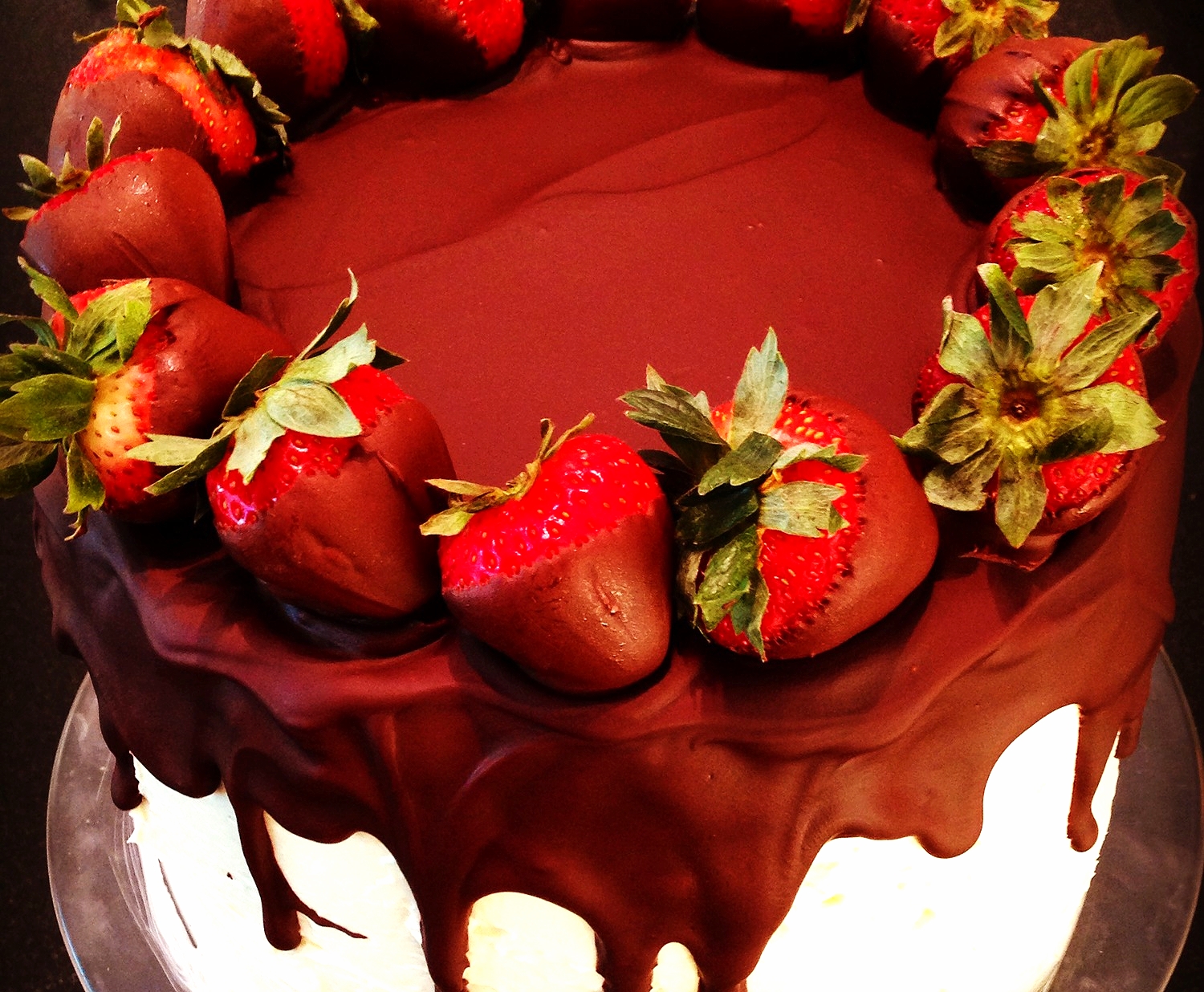 Shadow cake topped with chocolate dipped strawberries