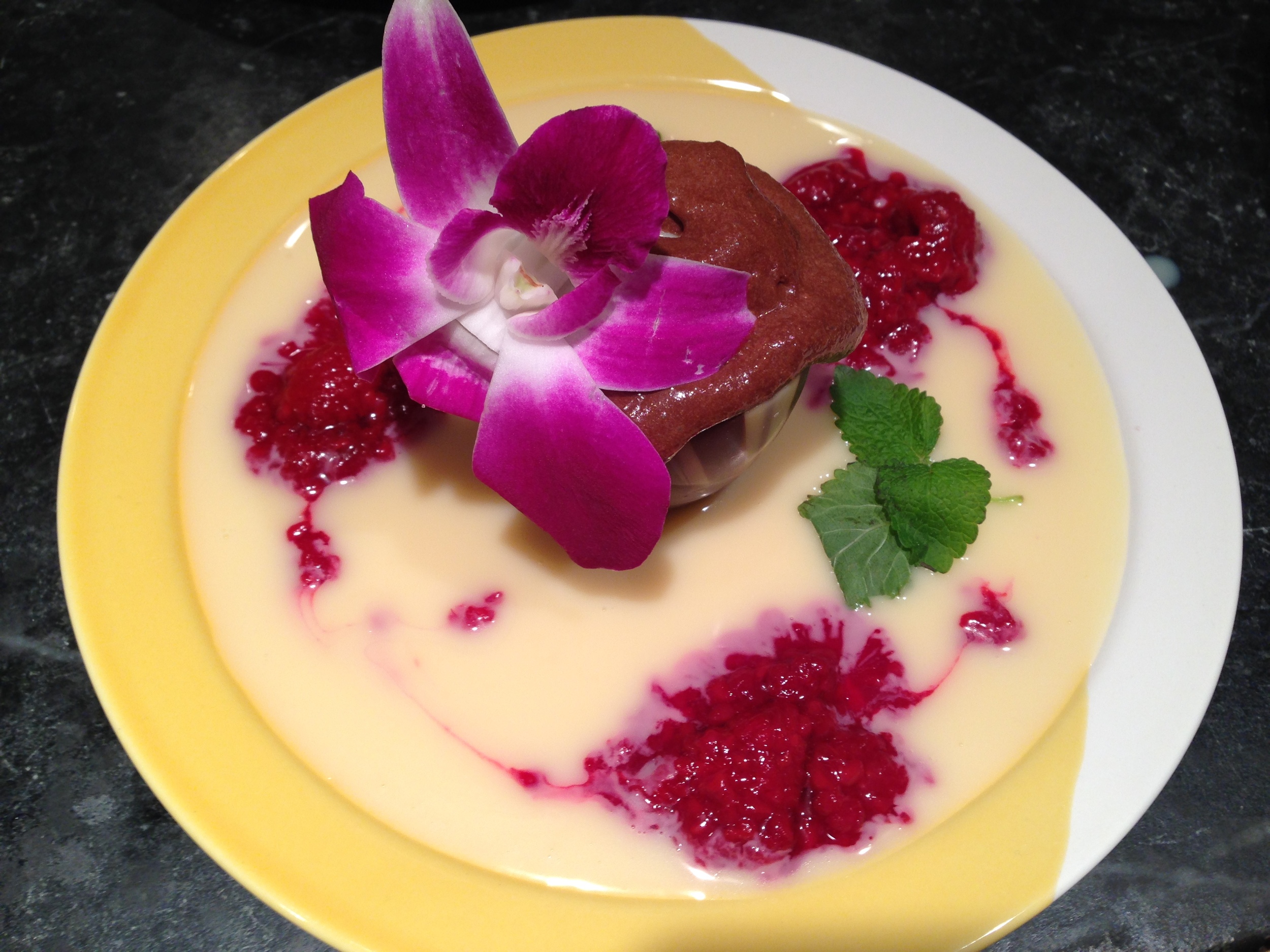 Chocolate mousse in marbled chocolate cup, white chocolate creme anglais, raspberry coulis, lemon verbena