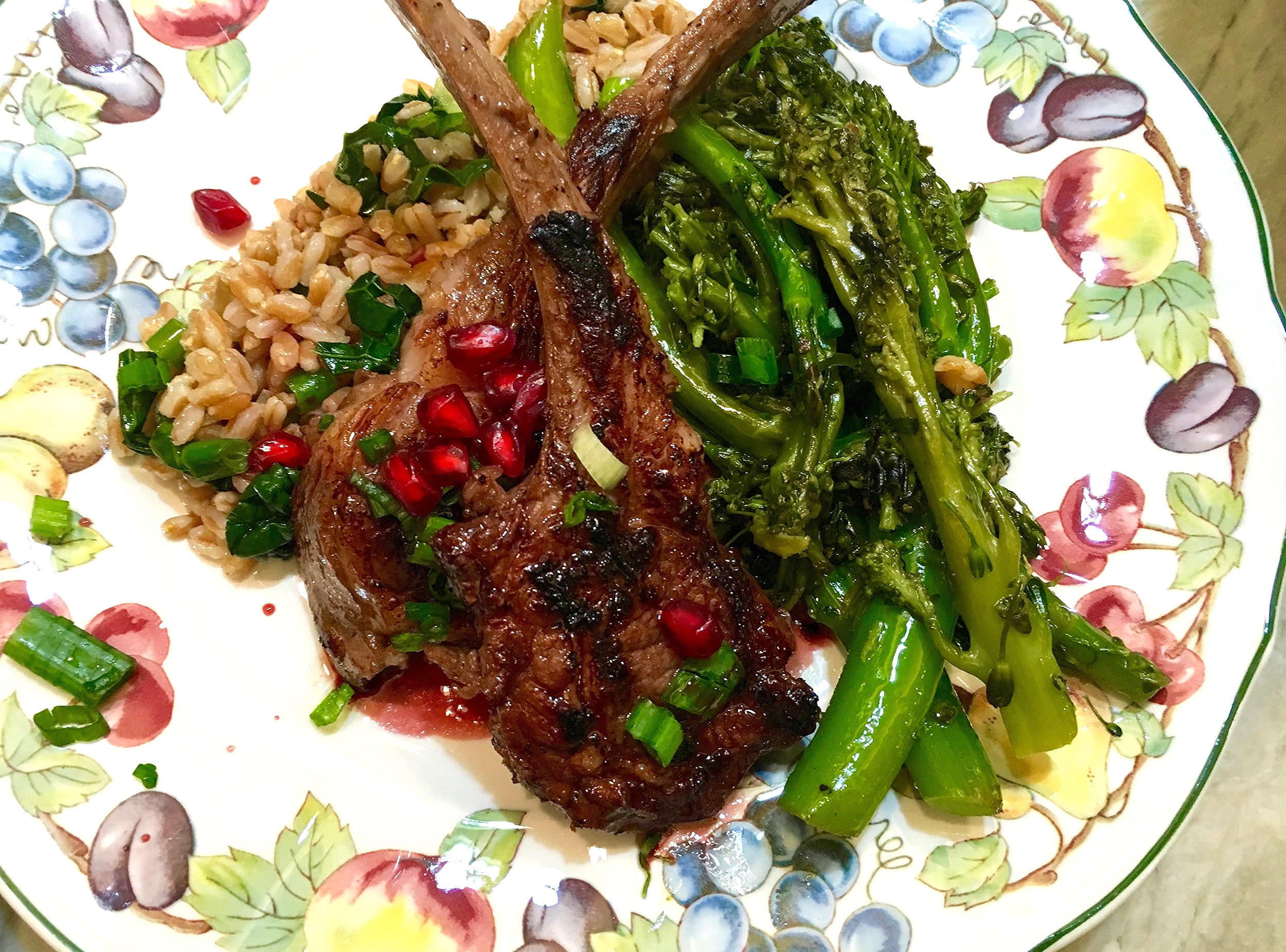 Lamb chops on warm herbed farro salad, brocoletti, spiced wine-pomegranate sauce