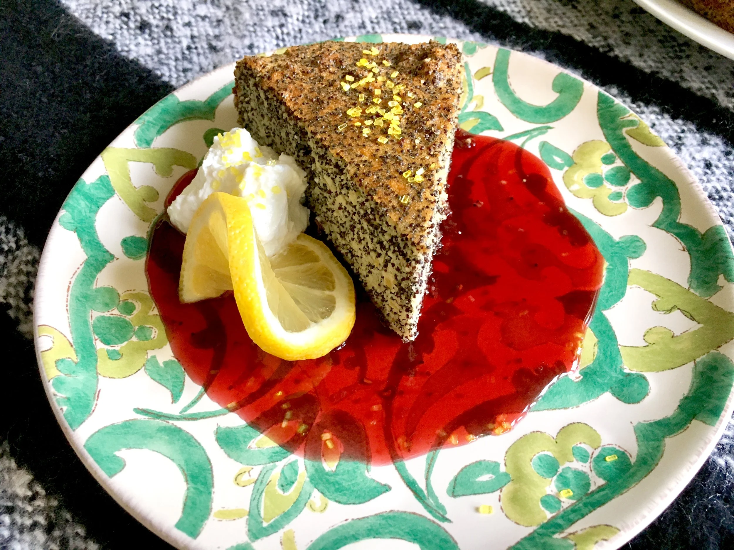 Rustic Italian flourless lemon-almond-poppyseed cake, four berry sauce, lemon sugar whipped cream