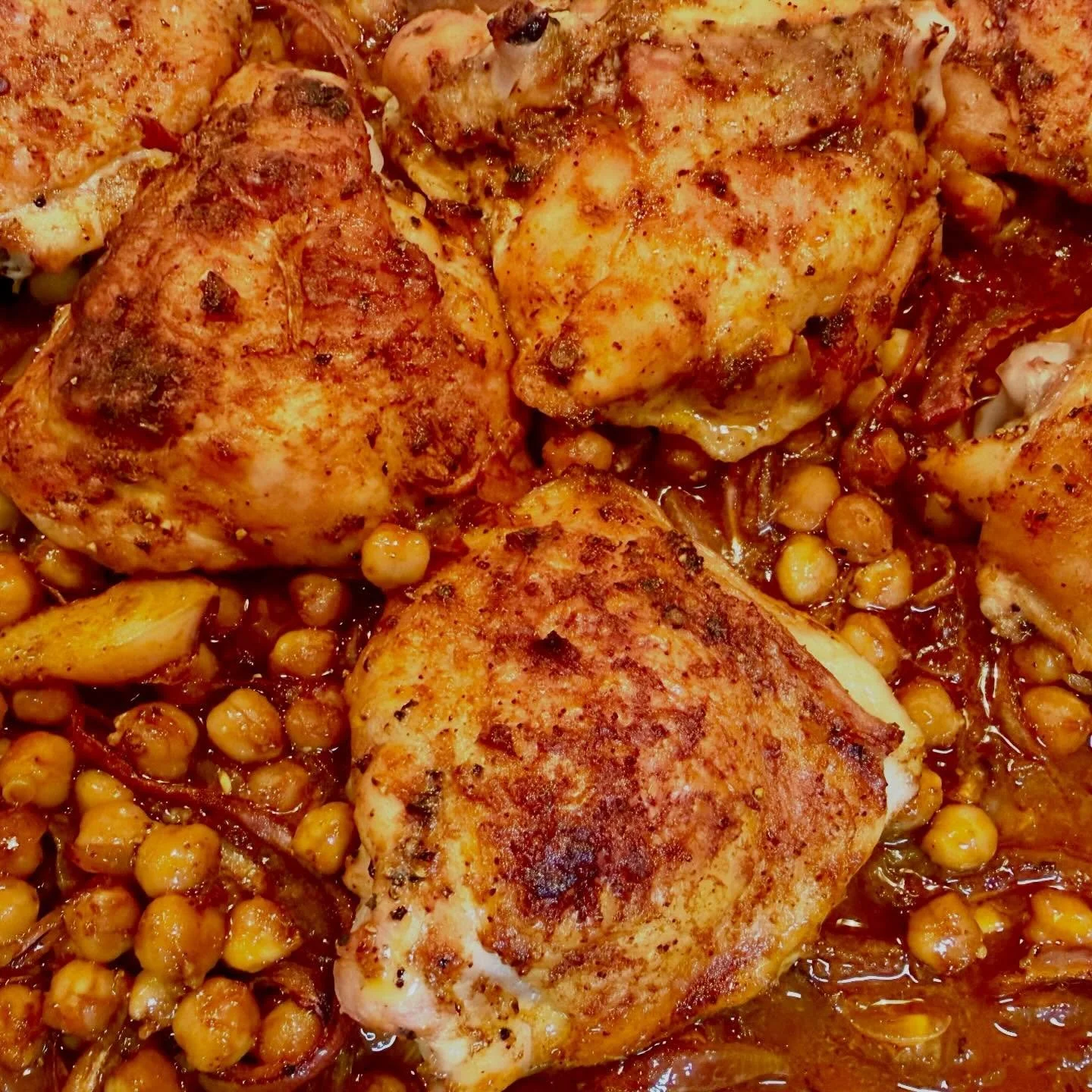 Chicken thighs roasted over chickpeas and red onions, tossed in a marinade of harissa, orange, and honey (and other good stuff). #bluaubergine #fabulousfood #catering #privatechef #mealdelivery