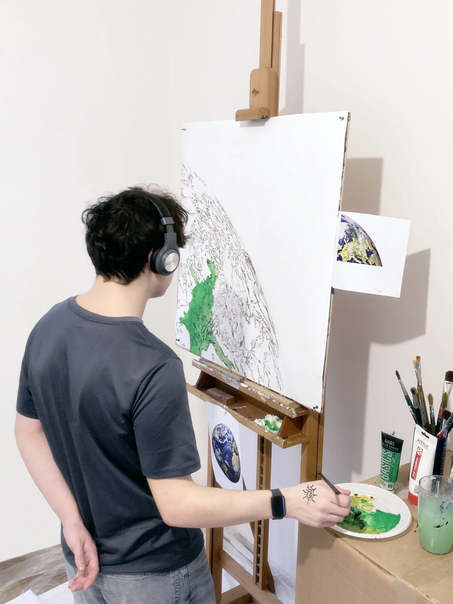 We Earth: young assistant painting 1 module in the art studio