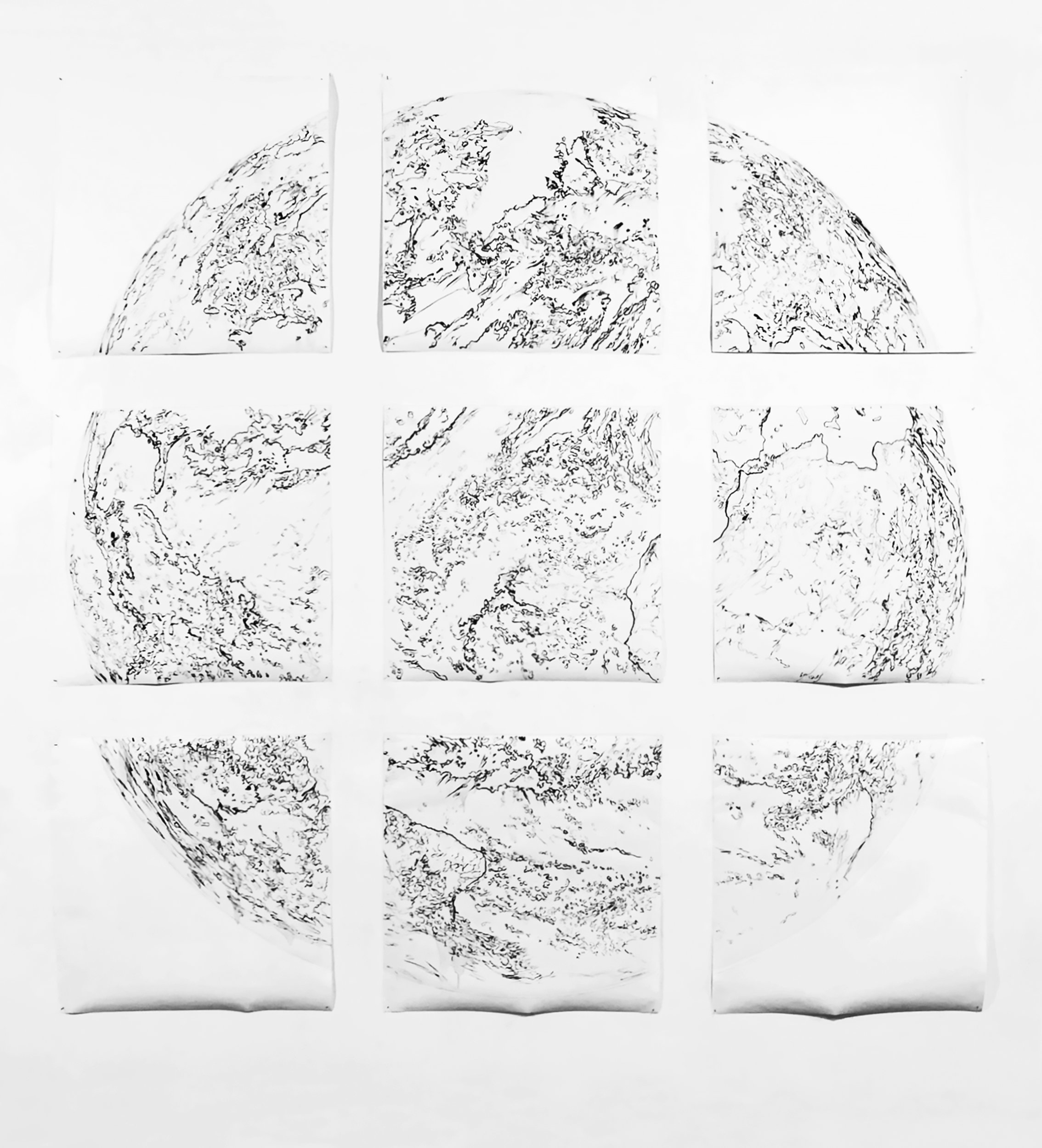 We Earth: WIP Phase 1; 9 paper modules with charcoal drawing in art gallery