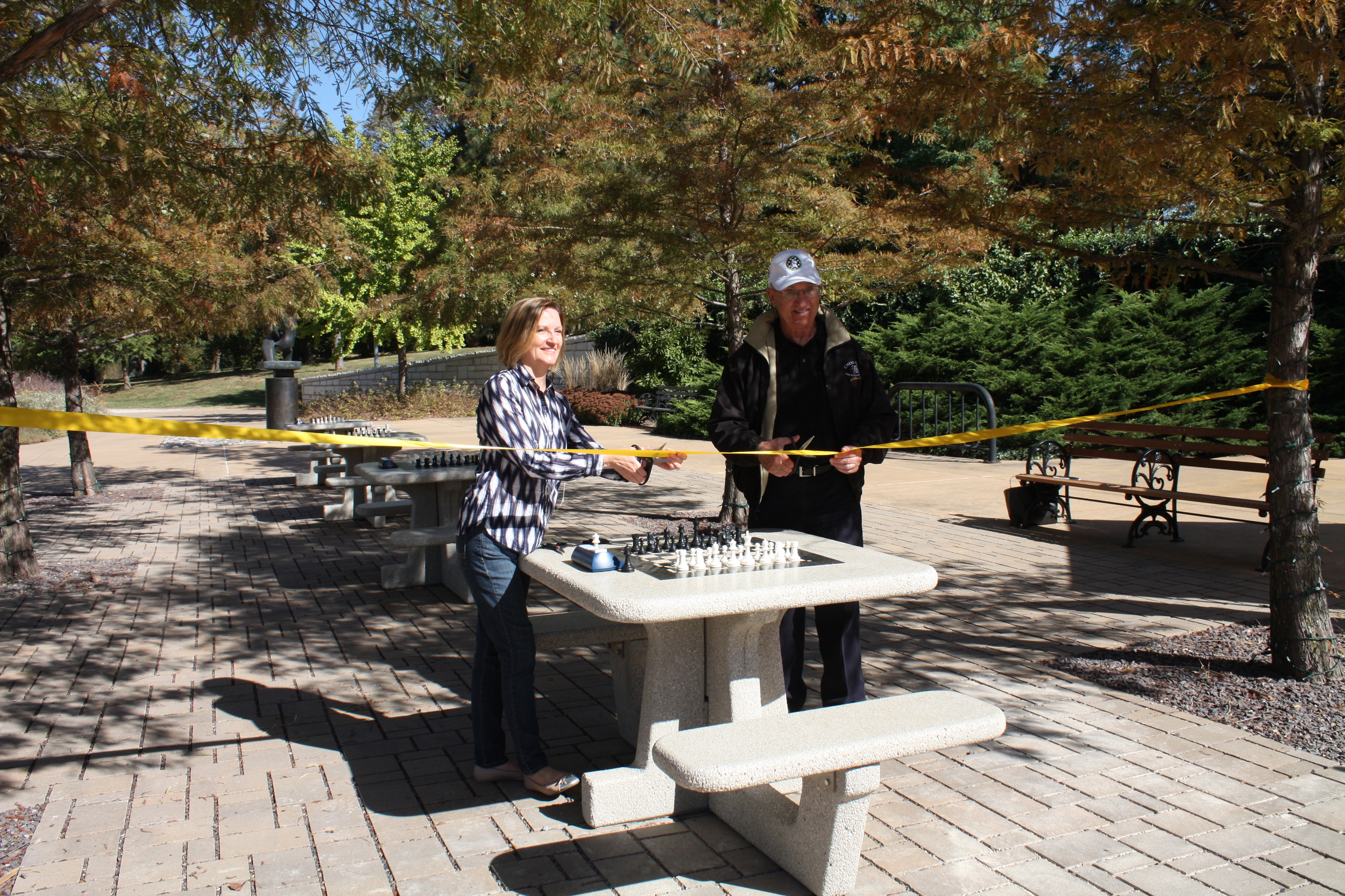  Forest Park Forever President and Executive Director Lesley S. Hoffarth, P.E. cuts the ribbon on Forest Park’s new chess plaza with Rex Sinquefield, founder of the Chess Club and Scholastic Center of Saint Louis 