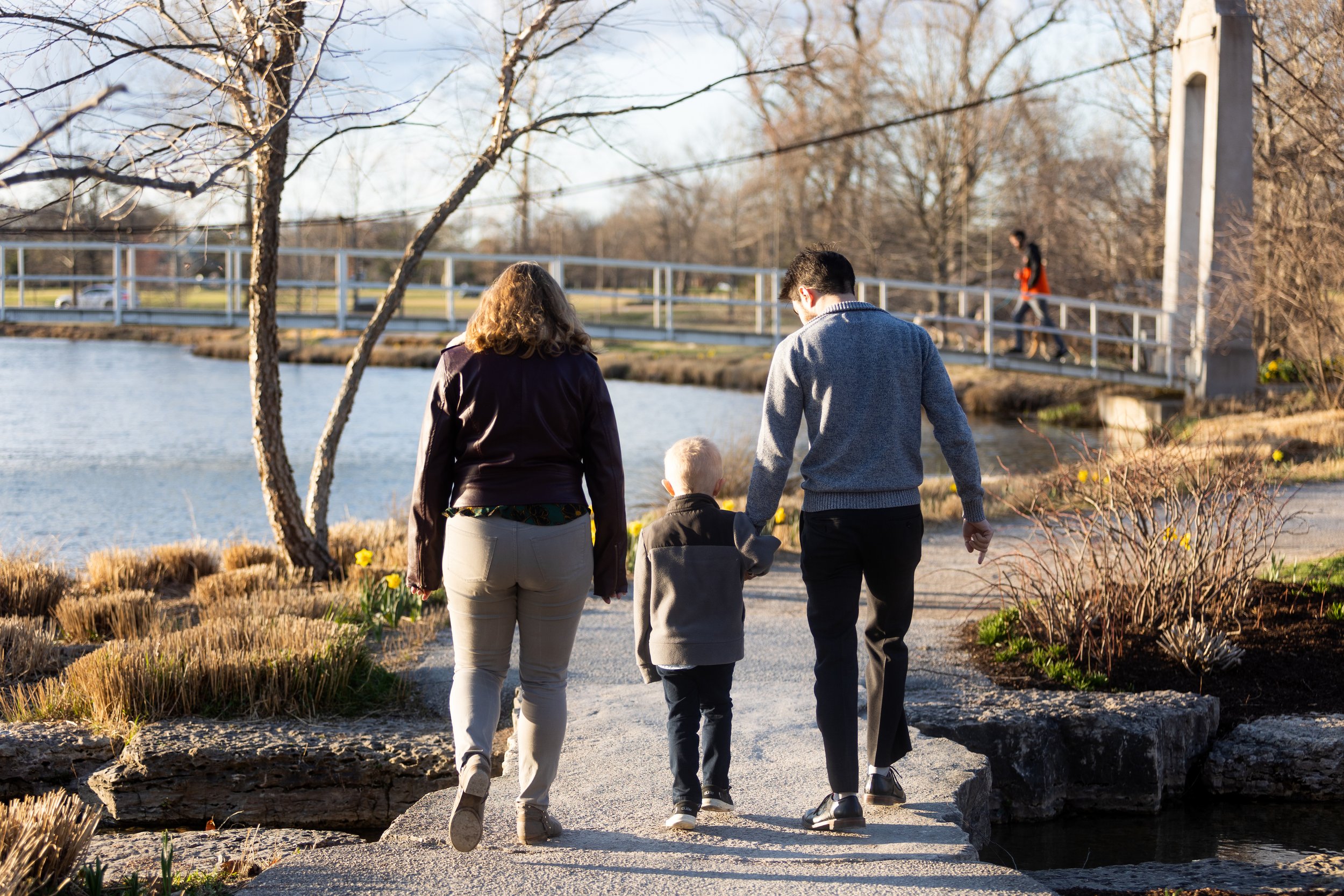  A couple walking with a child near the suspension bridge at Picnic Island 