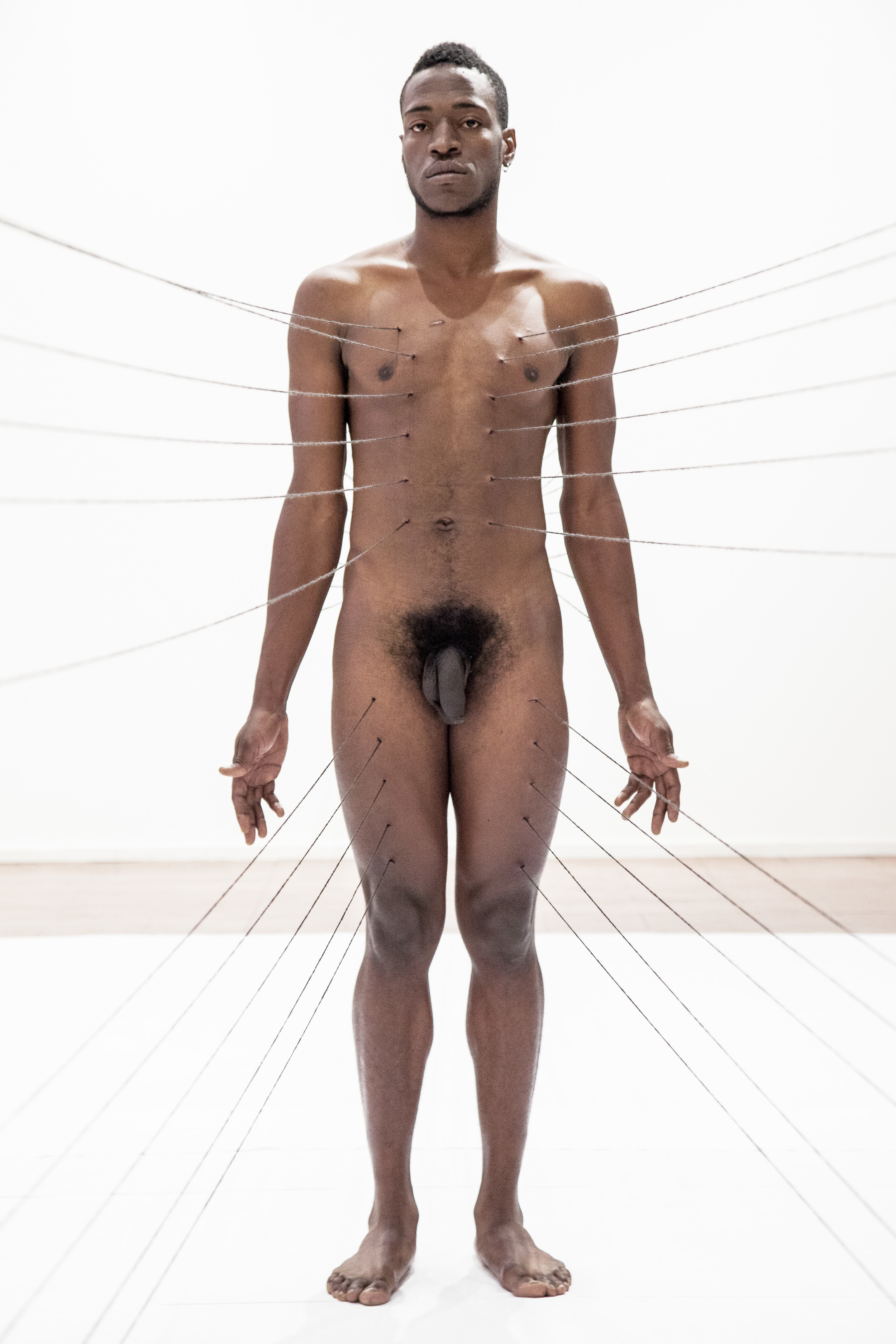 Carlos Martiel curated by Eugenio Viola performing "Punto de Fuga" at Nitsch Museum in Napoli, Italy in 2013. Photograph by Amedeo Benestante
