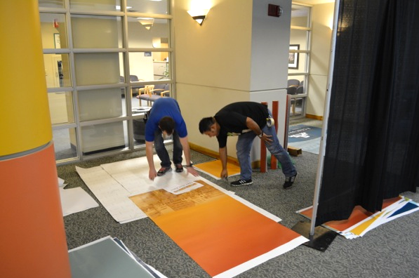 The design called for vinyl covering for the existing windows and walls, as well as custom painting of the columns in front of the exhibit spaces.