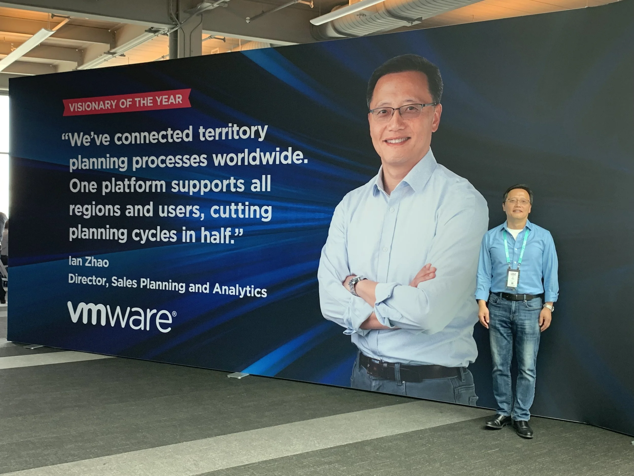 Here the subject is posed next to the final poster to show scale. Photography provided by client.