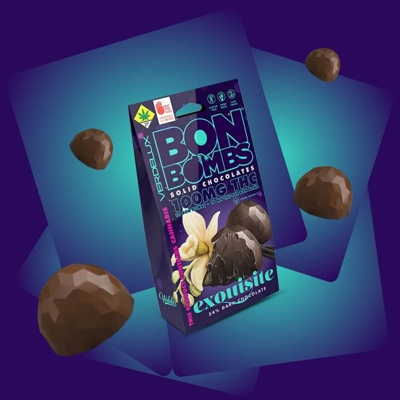A package of Bon Bombs solid chocolates with 100mg THC, featuring dark chocolate with cannabis certification, surrounded by scattered solid chocolate against a gradient blue background.