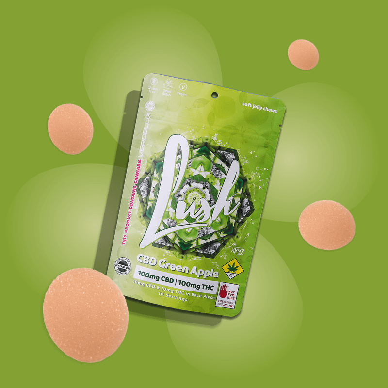 Green package of gummies called 'Lush' with CBD THC 1:1 and Green Apple flavor, surrounded by pink gummy candies on a green background.
