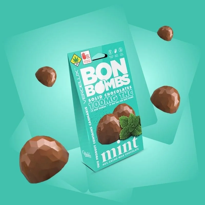 A turquoise green box labeled 'Bon Bombs' contains mint-flavored solid chocolates infused with 100mg THC each, surrounded by solid chocolate and mint leaves.