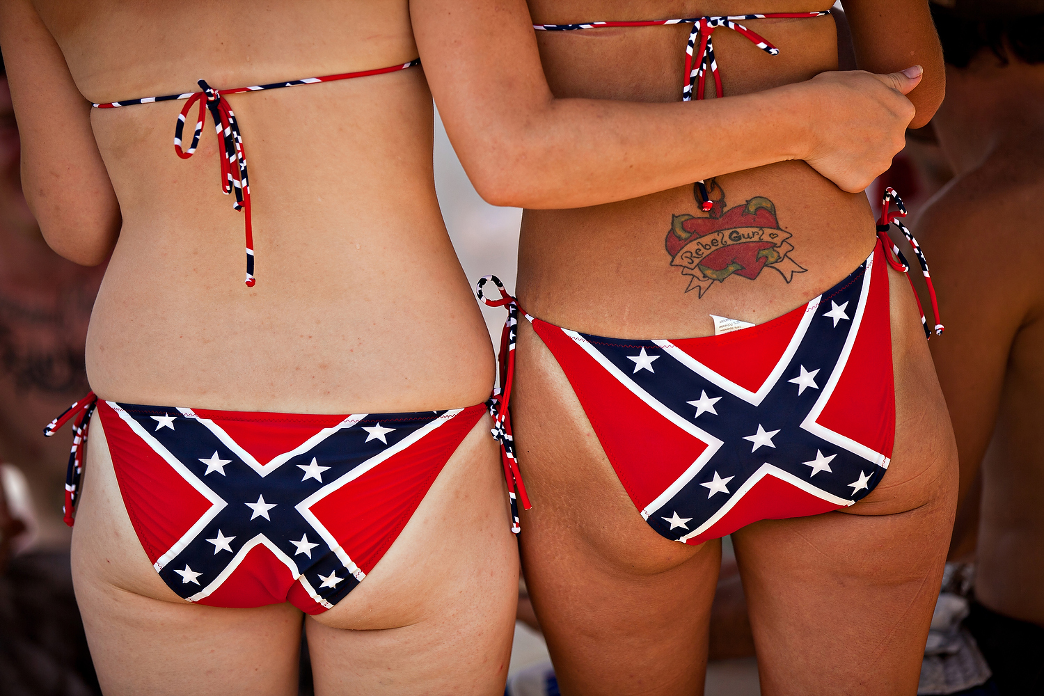 Two women wear confederate flag bikinis during the Summer Redneck Games on ...