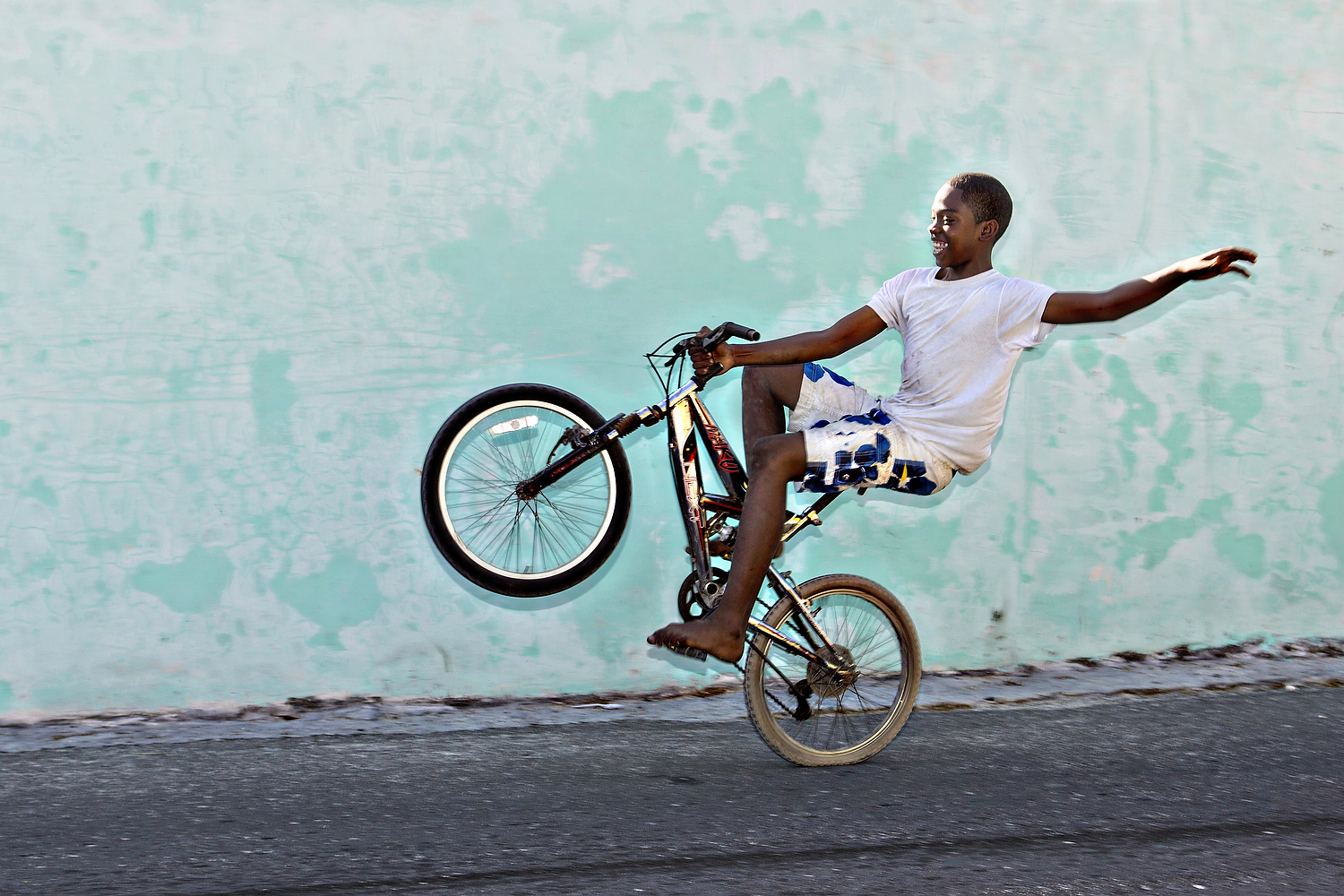  Bahamian boy rides his bicycle in Dunmore Town, Harbour Island, The Bahamas 