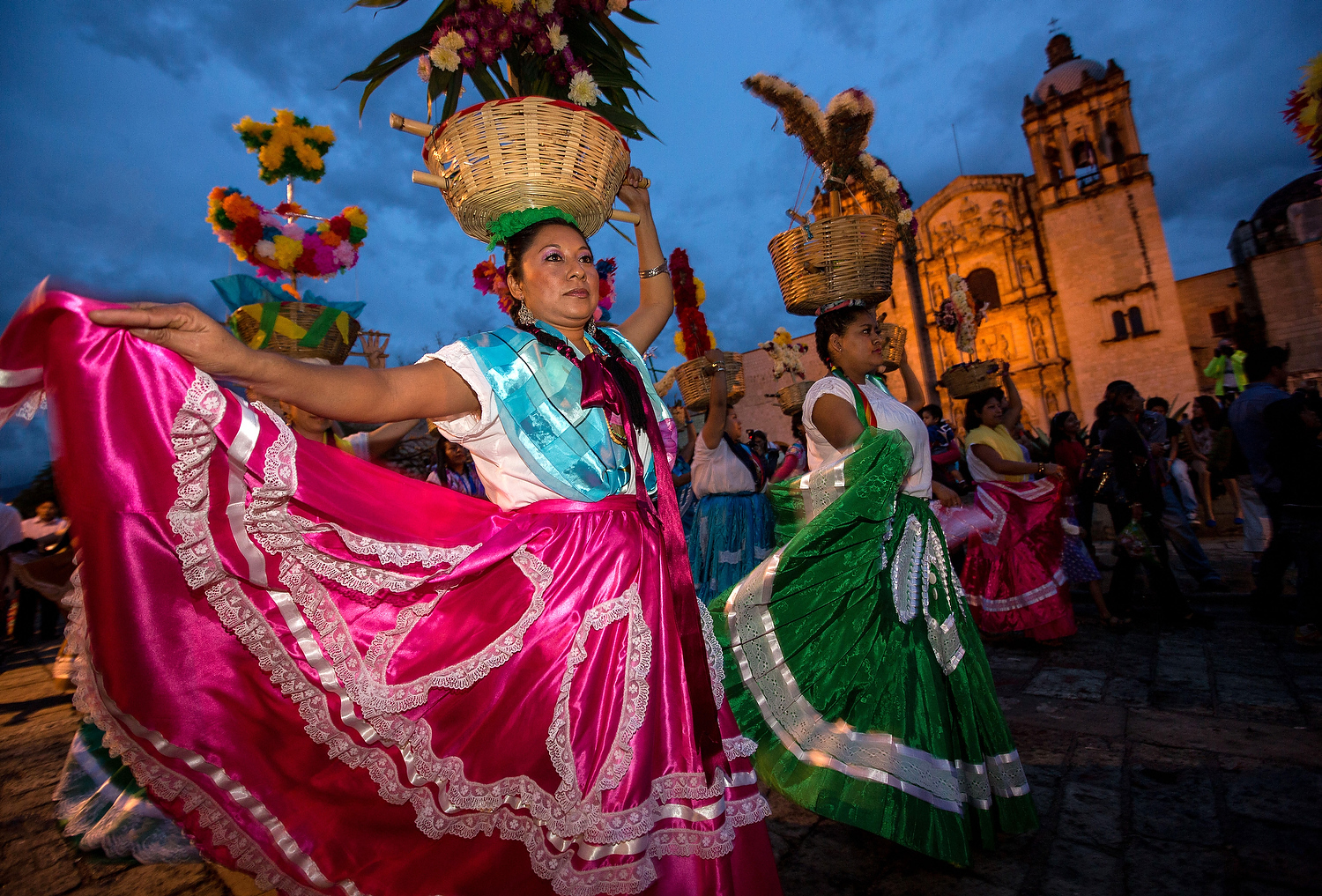  Young women dressed in traditional costumes parade in a comparsas past the Santo Domingo de Guzmán Church during the Day of the Dead Festival known in Spanish as Día de Muertos on November 2, 2013 in Oaxaca, Mexico. 