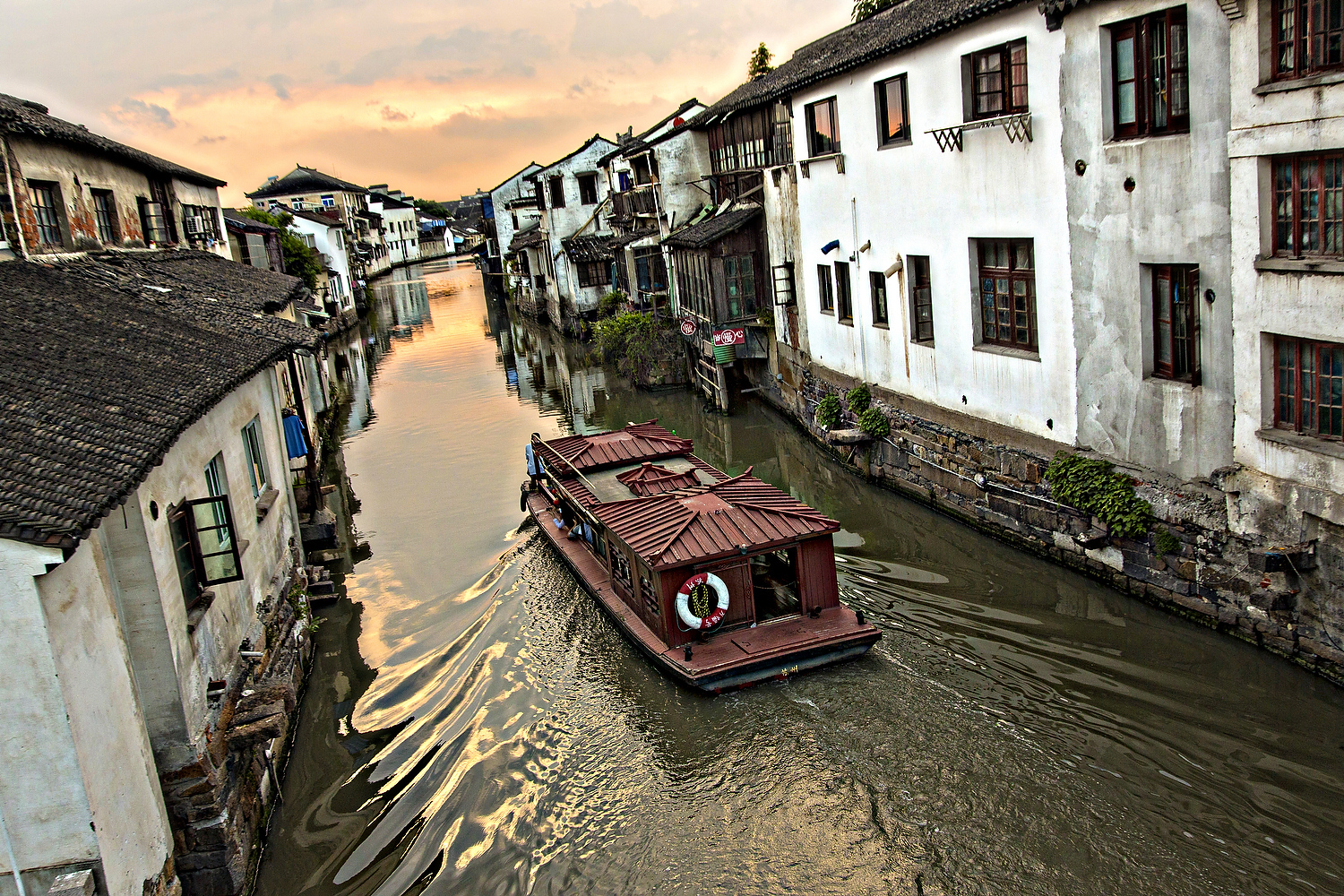  Boat travels along Shantang canal in Suzhou, China. 