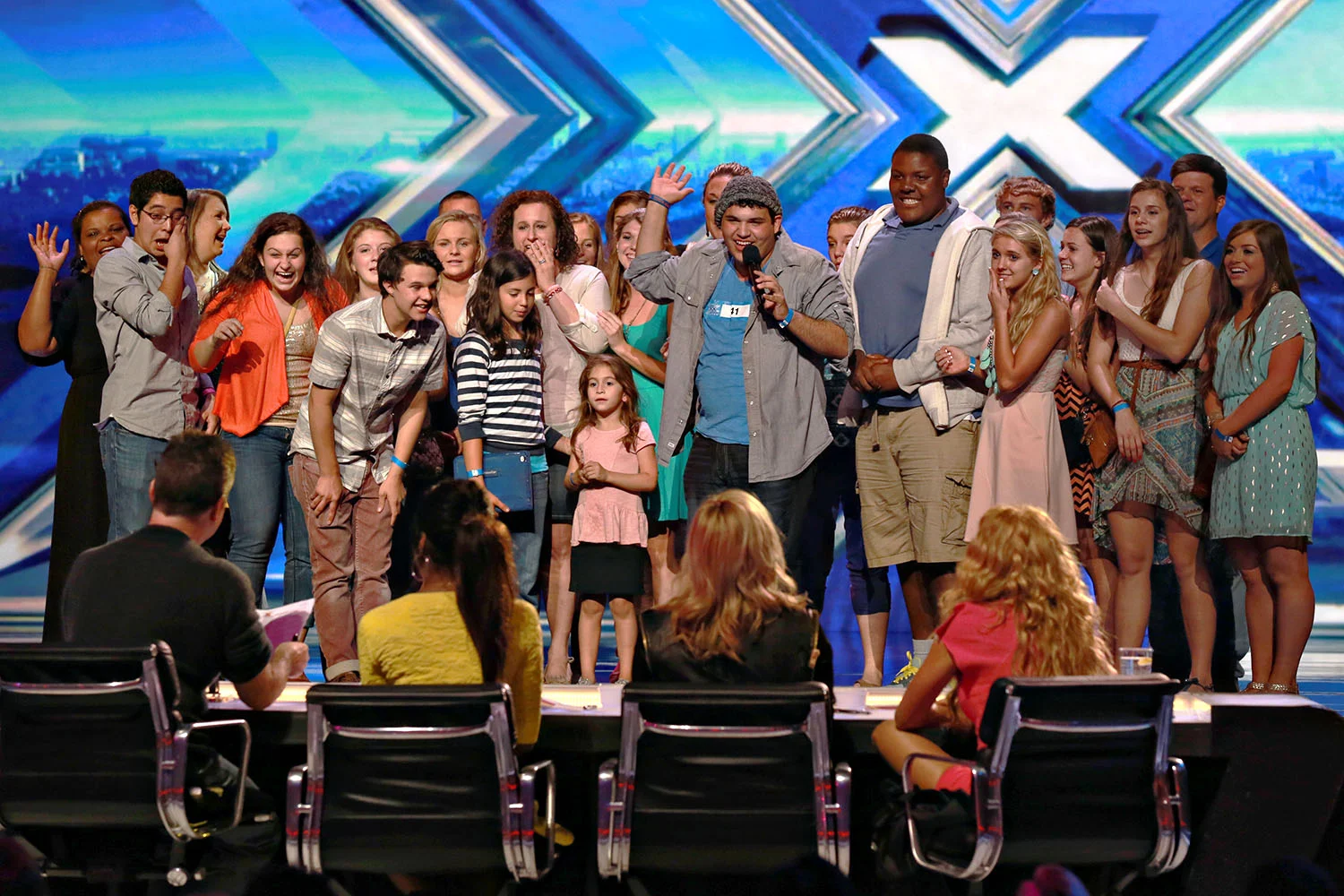 Singer Carlos Guevara is surrounded by his friends as he is chosen for the X-Factor in Charleston, SC