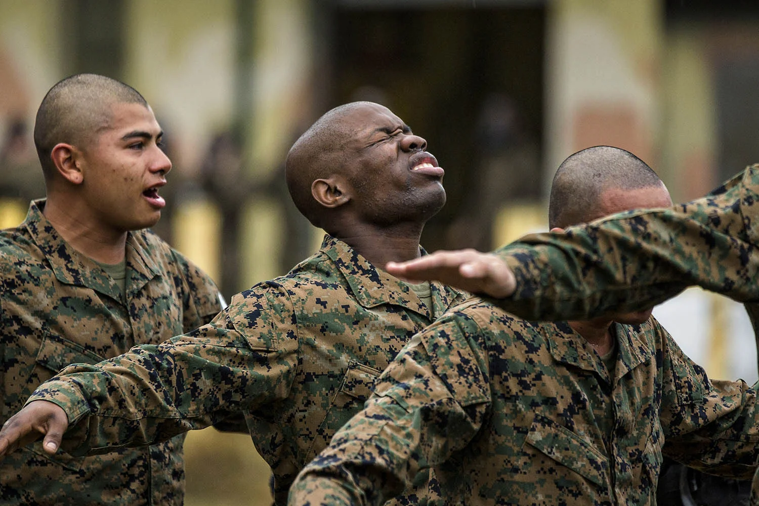 US Marine recruits choke and gasp for air after exiting the gas chamber during bootcamp January 13, 2014 in Parris Island, SC.