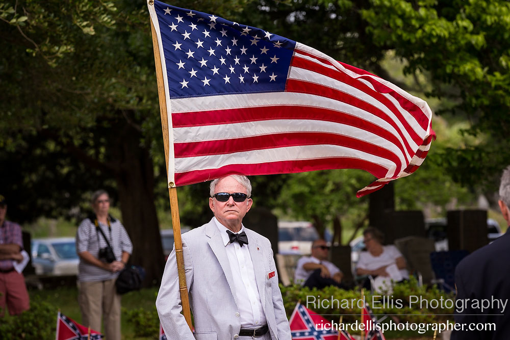 A descendant of Civil War soldiers holds the American flag at a ceremony marking Confederate Memorial Day at Magnolia Cemetery April 10, 2014 in Charleston, SC. Confederate Memorial Day honors the approximately 258,000 Confederate soldiers that died in the American Civil War. 