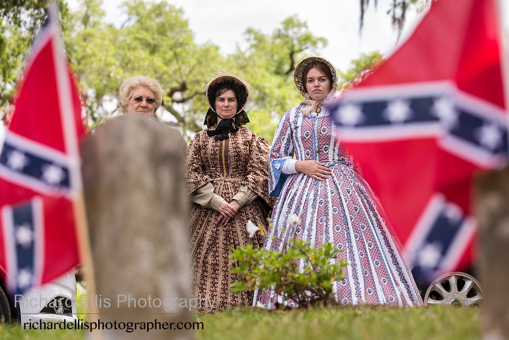 Re-enactors dressed in Civil War era hoop skirts stand at during Confederate Memorial Day events at Magnolia Cemetery April 10, 2014 in Charleston, SC. Confederate Memorial Day honors the approximately 258,000 Confederate soldiers that died in the American Civil War. 