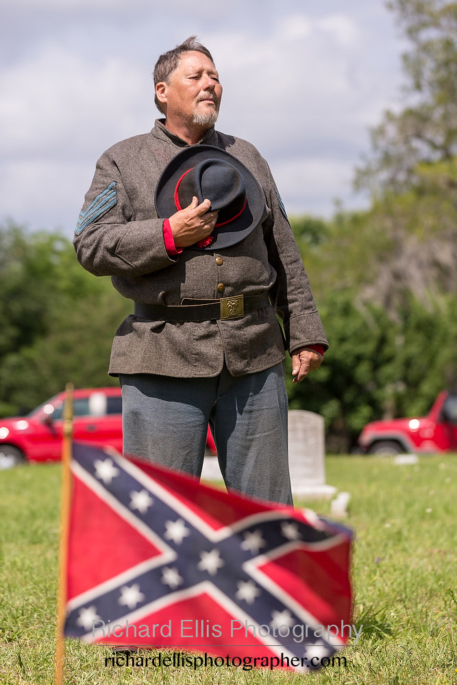 A Civil War re-enactor stands for a moment of silence during Confederate Memorial Day events at Magnolia Cemetery April 10, 2014 in Charleston, SC. Confederate Memorial Day honors the approximately 258,000 Confederate soldiers that died in the American Civil War. 