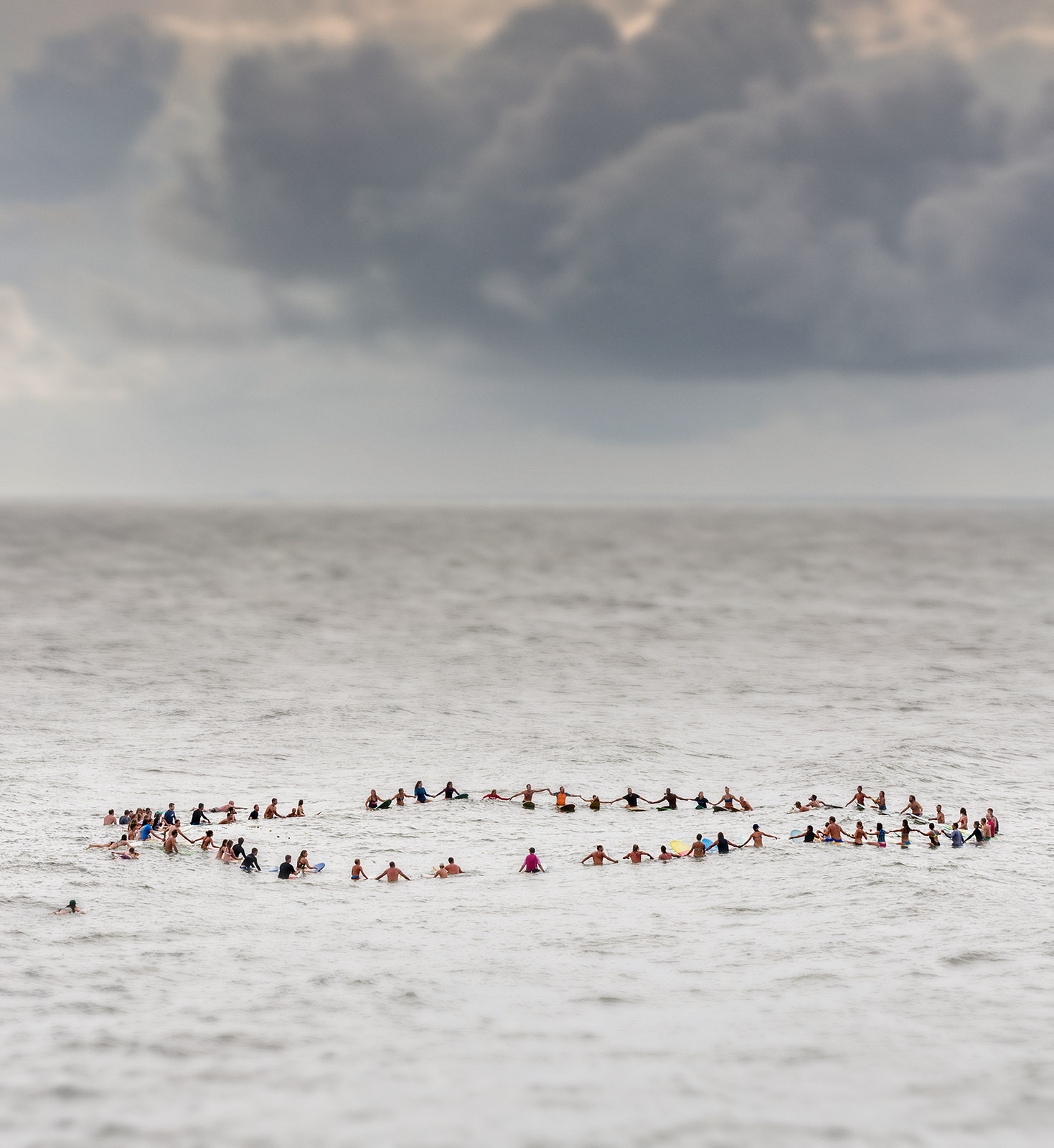 Charleston area surfers join hands in a floating circle during a traditional memorial paddle out to honor and remember the nine people killed at the historic mother Emanuel African Methodist Episcopal Church in Folly Beach, South Carolina. 