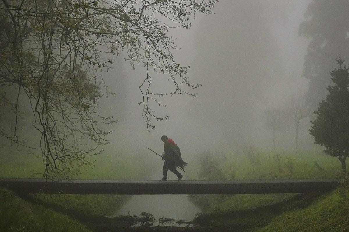  A lone Roman Catholic pilgrim called a Romeiro, walks across a fog shrouded footbridge during their 8-day trek around the Azorean Island of Sao Miguel, March 30, 2023 in Furnãs, Portugal. The pilgrims visit 100 shrines and churches during the event 