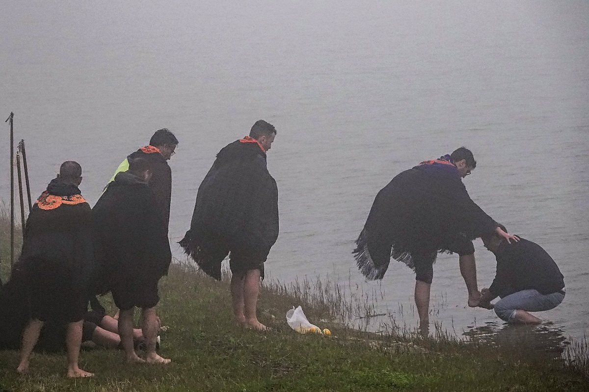  A Roman Catholic priest washes the feet of pilgrims known as Romeiros, on a misty day at the shore of Lake Furnas, March 30, 2023 in Lagoa das Furnãs, Portugal. The pilgrims visit 100 shrines and churches during their 8-day trek around the Azorean I