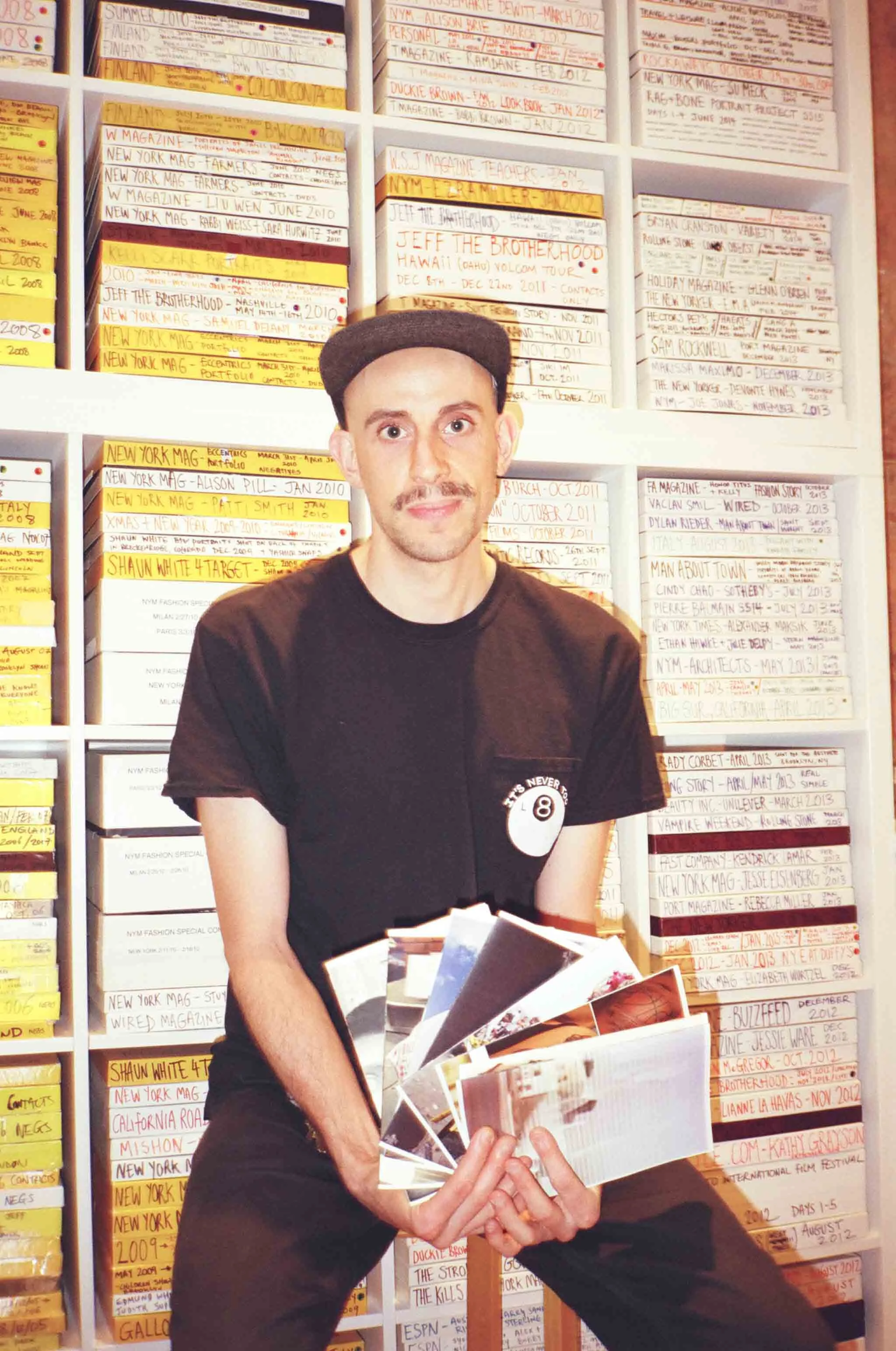 Andreas Laszlo Konrath in front of his bookcase of film negatives in his studio.
